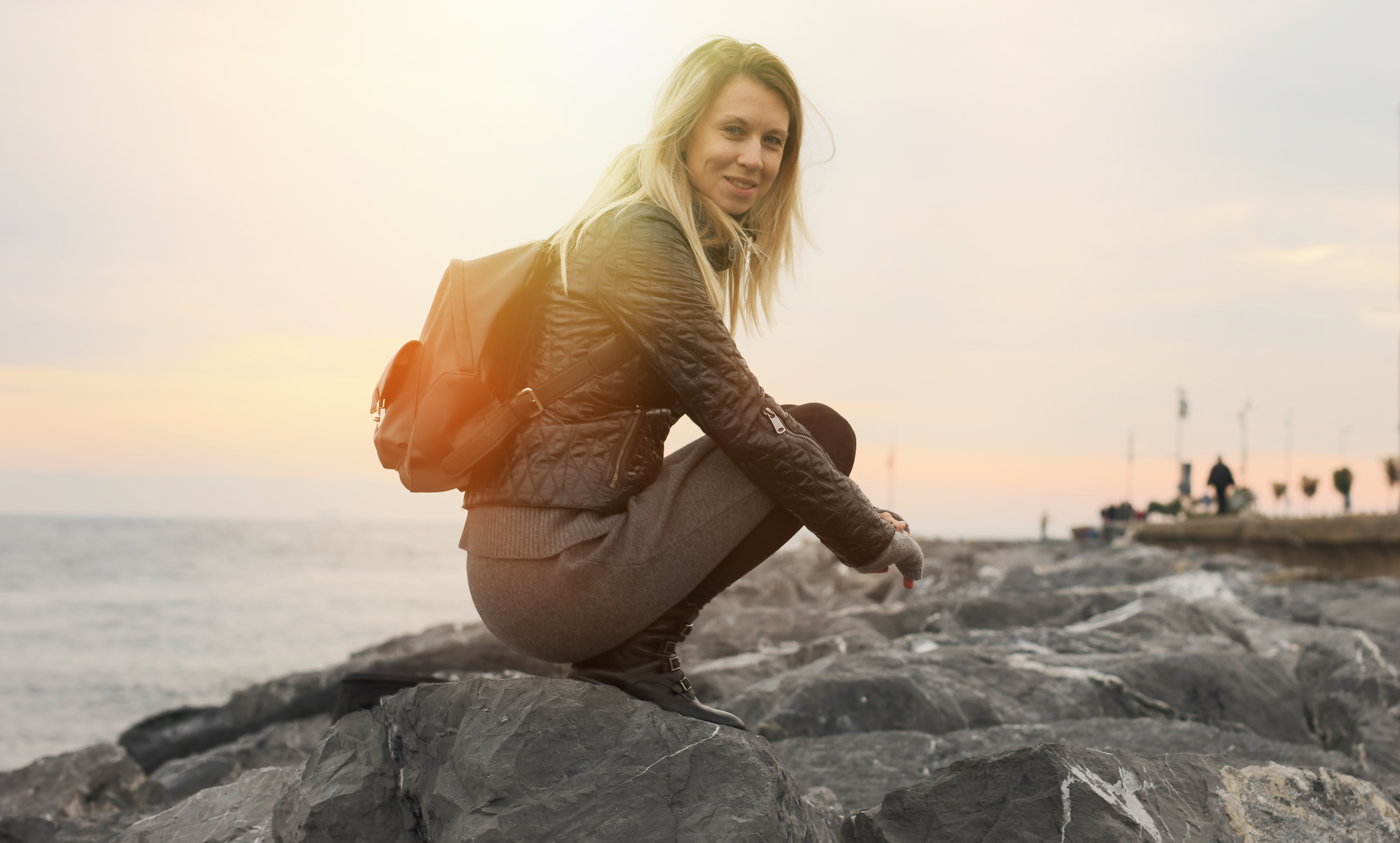 female travel nurse smiling on beach